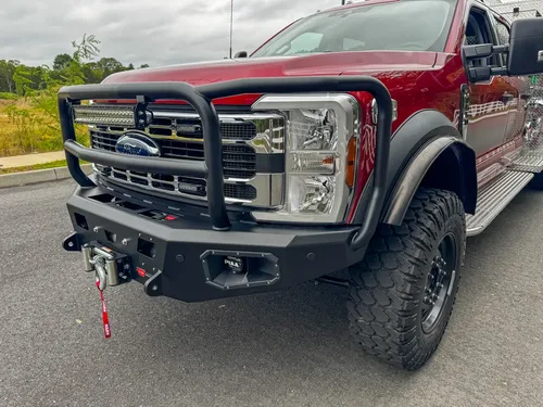 Front bumper close-up showing winch mount, tow point, and control ports.